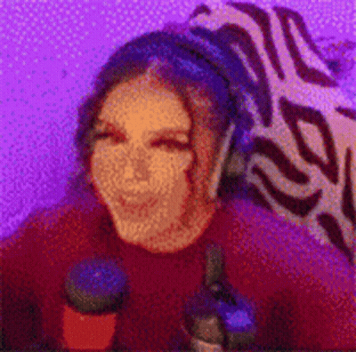 Woman With Headphones At Microphone In Purple Room GIF