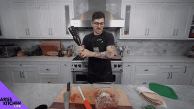 Woman With Headphones Dancing In Kitchen Saying Complete GIF
