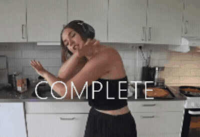 Woman With Headphones Dancing In Kitchen Saying Complete GIF