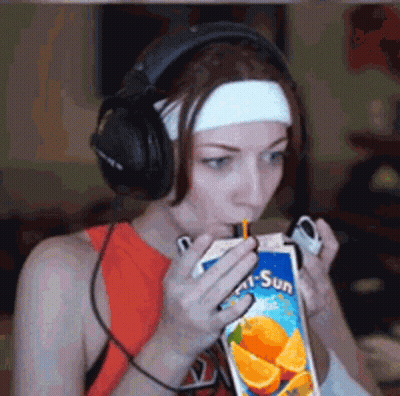 Woman With Headphones Drinking Orange Juice GIF