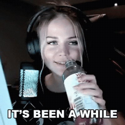Woman With Headphones Drinking Water Saying It's Been A While GIF