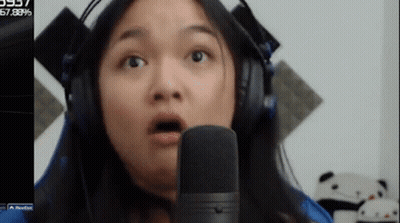Woman With Headphones Funny Face Into Microphone GIF