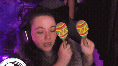 Woman With Headphones Holding Colorful Maracas GIF