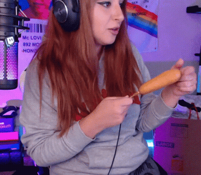 Woman With Headphones Holding Corn Dog At Mic Saying MC Love GIF