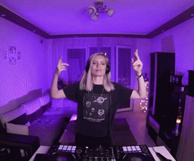 Woman With Headphones In Front Of DJ Controller GIF