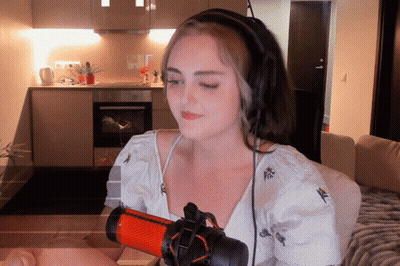 Woman With Headphones In Front Of Red And Black Microphone GIF