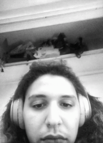 Woman With Headphones Looking At Camera GIF