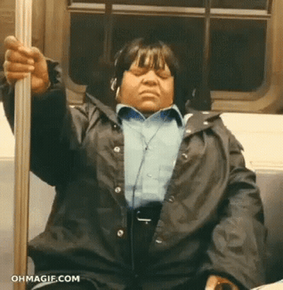 Woman With Headphones On Subway Holding Pole GIF