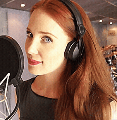 Woman With Headphones Smiling At Microphone GIF