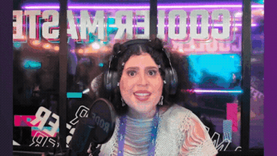 Woman With Headphones Smiling At Microphone With T2 AM On Window GIF