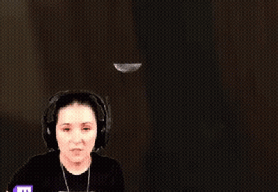 Woman With Headphones Standing in Front of Wall With Flying Feather