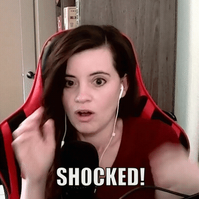 Woman With Headphones Surprised In Red Chair GIF