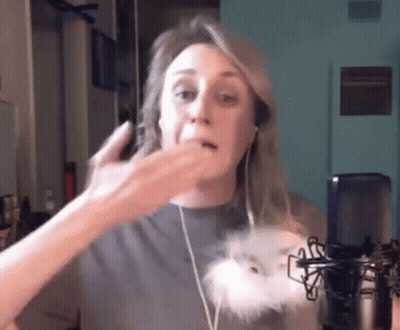 Woman With Headphones Talking Into Microphone Holding Stuffed Animal GIF