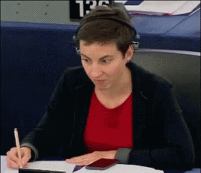 Woman With Headphones Writing At Desk GIF