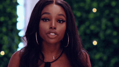 Woman With Hoop Earrings And Letter J On Neck GIF