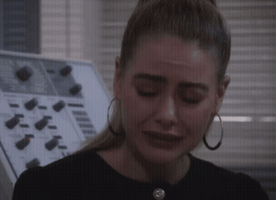 Woman With Hoop Earrings Crying In Front Of Control Panel GIF