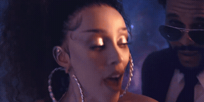 Woman With Hoop Earrings Next To Man In Suit GIF
