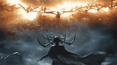 Woman With Horns Standing In Front Of Flock Of Birds Flying In Sky GIF