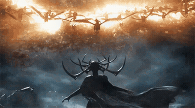 Woman With Horns Standing In Front Of Flock Of Birds GIF