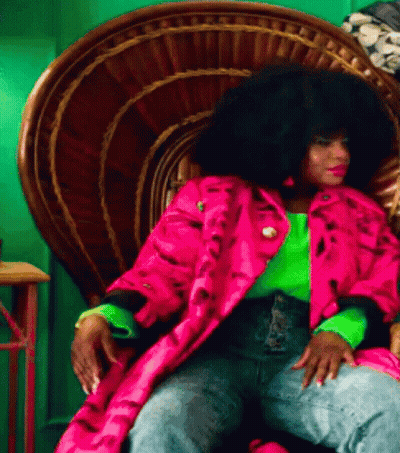 Woman With Large Afro Sitting In Chair GIF