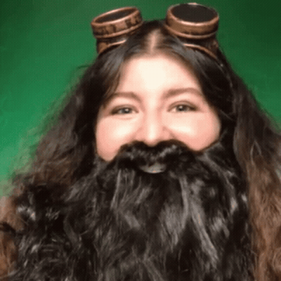 Woman With Long Beard And Goggles Smiling GIF