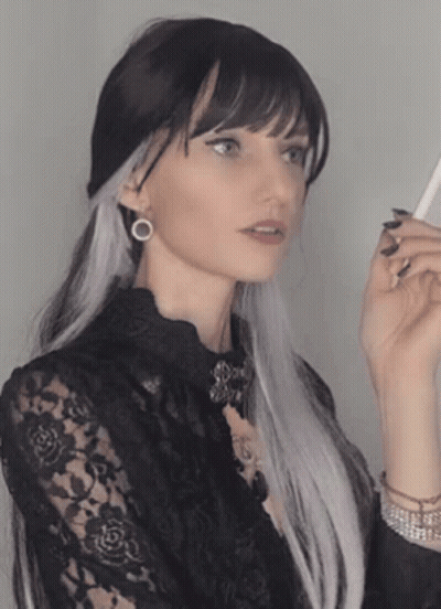 Woman With Long Black And White Hair In Black Lace Shirt GIF