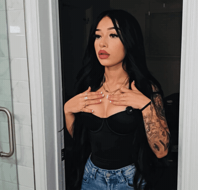 Woman With Long Black Hair And Arm Tattoo GIF