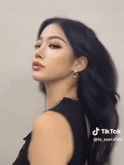 Woman With Long Black Hair and Earrings in Black Tank Top