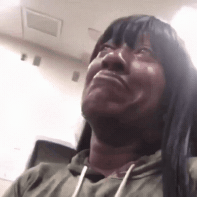 Woman With Long Black Hair And Green Hoodie Making Funny Face GIF