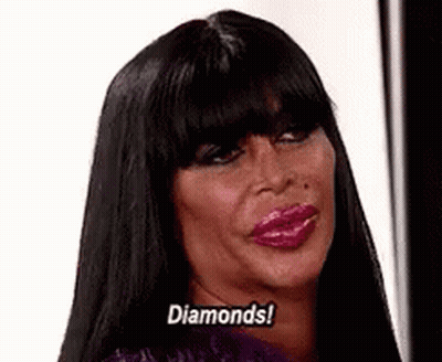 Woman With Long Black Hair And Pink Lips Saying Diamonds GIF