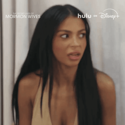 Woman With Long Black Hair And Plunging Neckline Surprised GIF