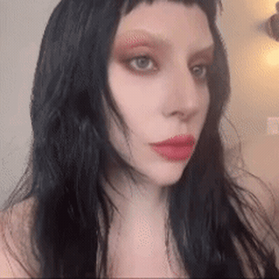Woman With Long Black Hair and Red Lips Taking Selfie