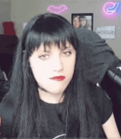 Woman With Long Black Hair And Red Lips Wearing Headphones And Choker GIF