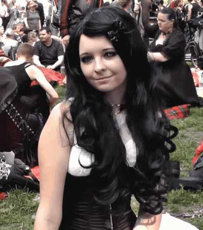Woman With Long Black Hair And White Top Holding KTS License Plate GIF