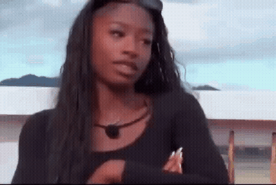 Woman With Long Black Hair Crossed Arms Looking At Camera GIF