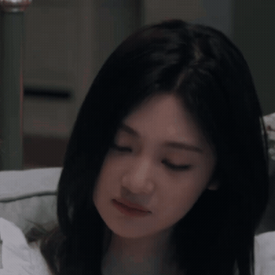 Woman With Long Black Hair Eyes Closed On Bed GIF