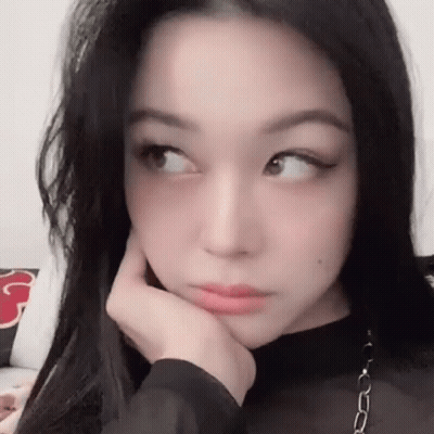 Woman With Long Black Hair Holding Hand To Face GIF