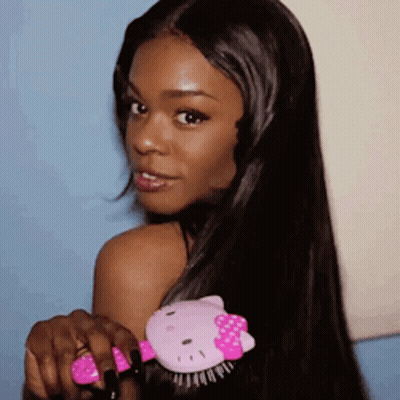 Woman With Long Black Hair Holding Hello Kitty Brush GIF