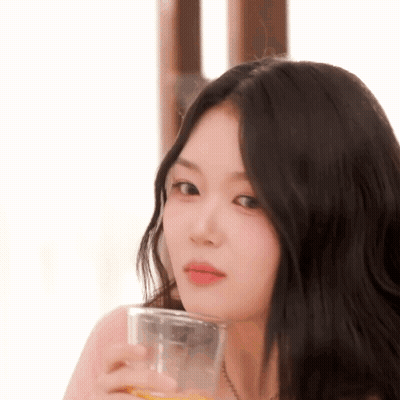Woman With Long Black Hair Holding Orange Juice GIF