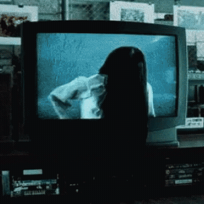 Woman With Long Black Hair In Front Of Television GIF