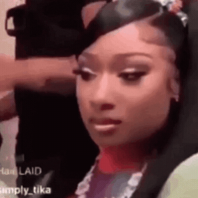 Woman With Long Black Hair In White Fur Coat Flipping Off GIF