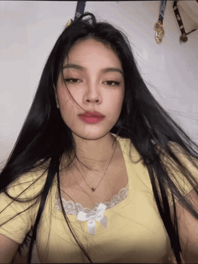 Woman With Long Black Hair In Yellow Shirt GIF