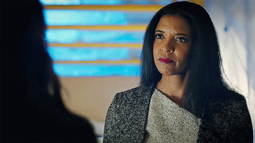 Woman With Long Black Hair Looking At Another Woman GIF