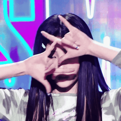 Woman With Long Black Hair Making Face With Hands GIF