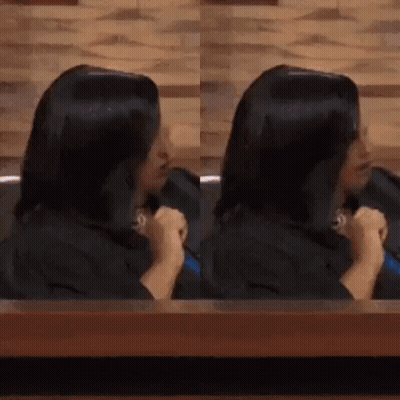 Woman With Long Black Hair Sitting At Table GIF