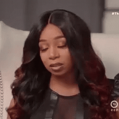 Woman With Long Black Hair Sitting On Couch GIF