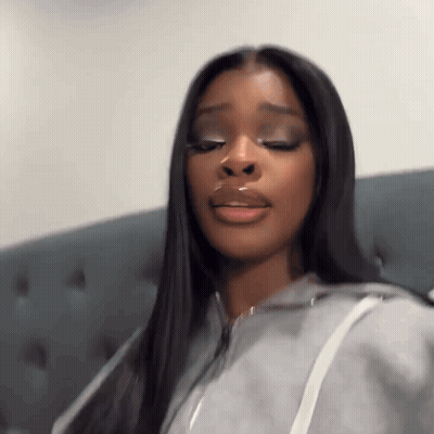 Woman With Long Black Hair Sitting On Couch Eyes Closed Mouth Open GIF