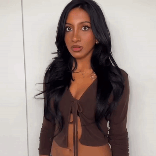 Woman With Long Black Hair Wearing Brown Top GIF