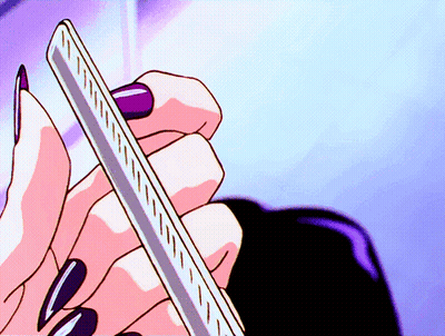 Woman With Long Black Nails Holding Ruler GIF
