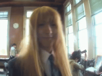 Woman With Long Blonde Hair And Tie Smiling GIF